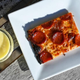 Pepperoni pizza slice beside pineapple condiment